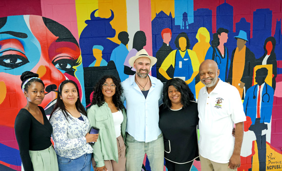 READI mural artist and community members in front of mural.