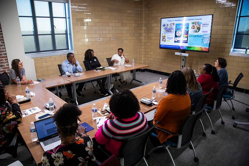 Members of the different community groups around a table