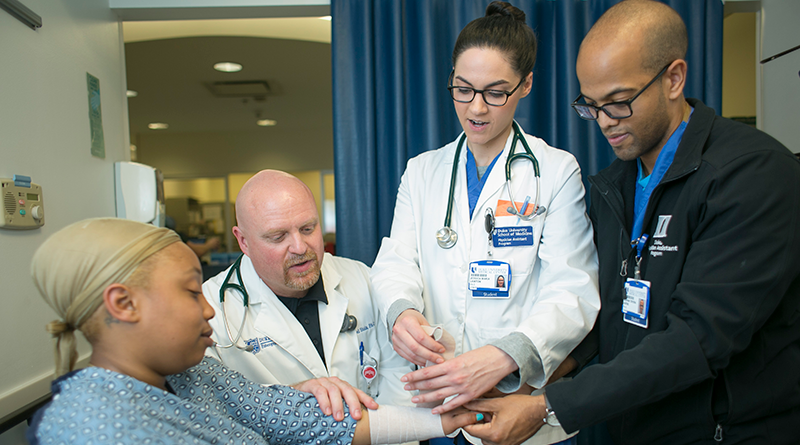 clinicians bandaging a patients arm