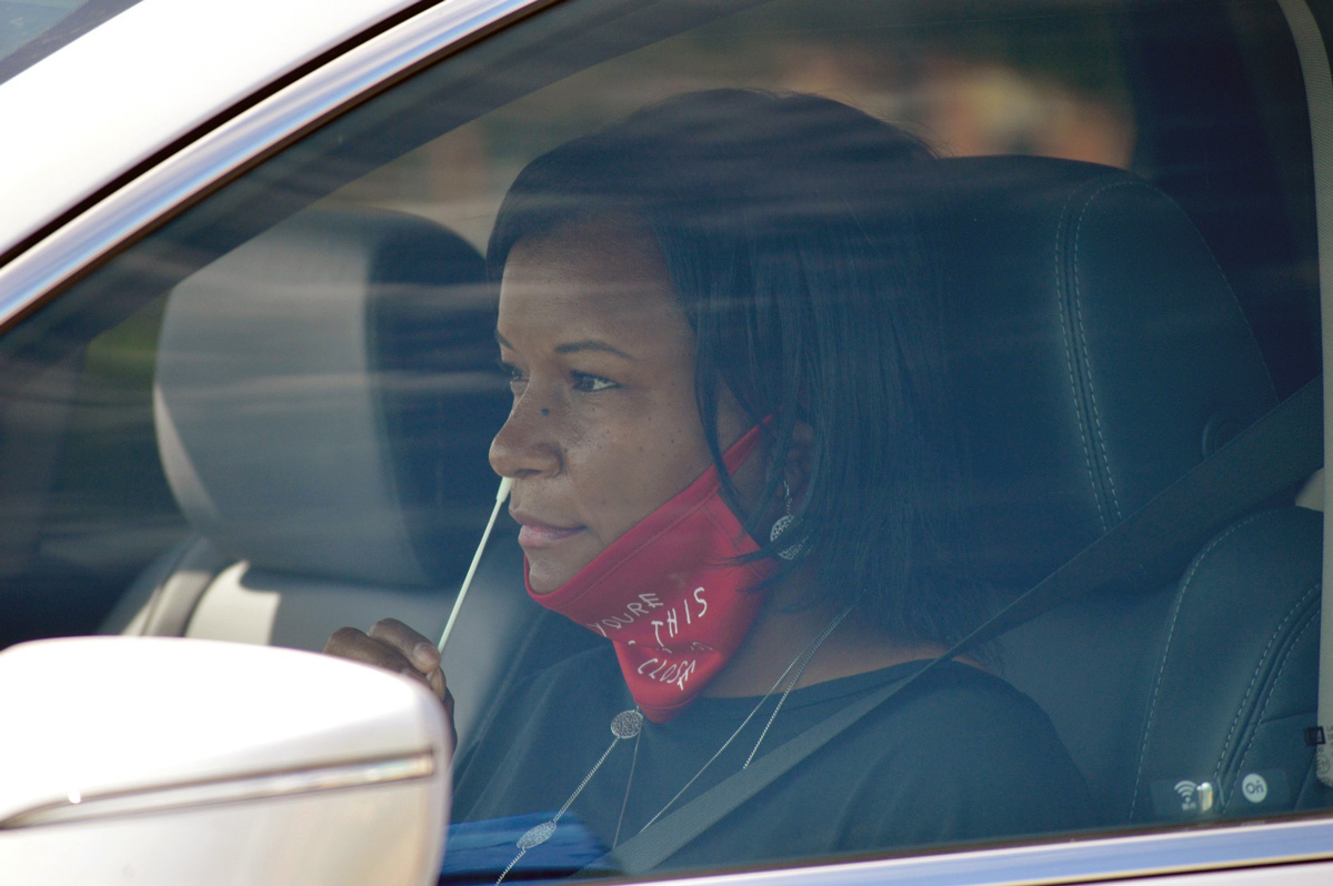 A MURDOCK C3PI study participant completes a nasal swab during enrollment in 2020. Photo by Duke CTSI 