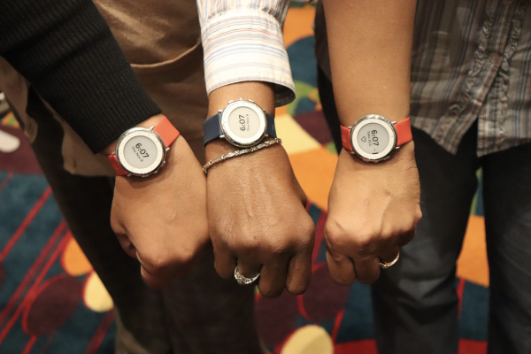 The outstretched arms of three Duke participants in the Project Baseline Health Study, showing the investigational study watch on each wrist.