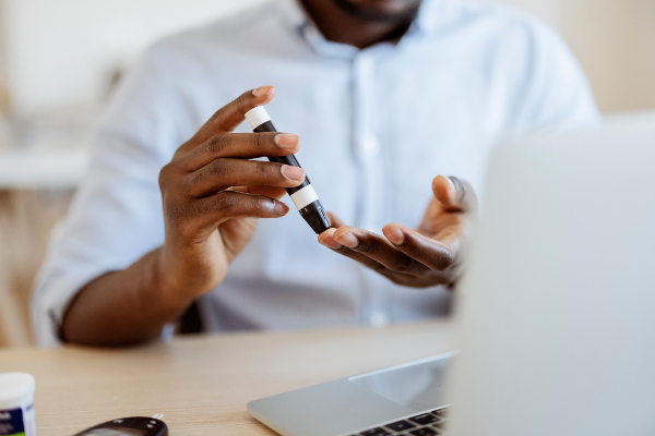 Stock photo of a person checking their blood glucose levels