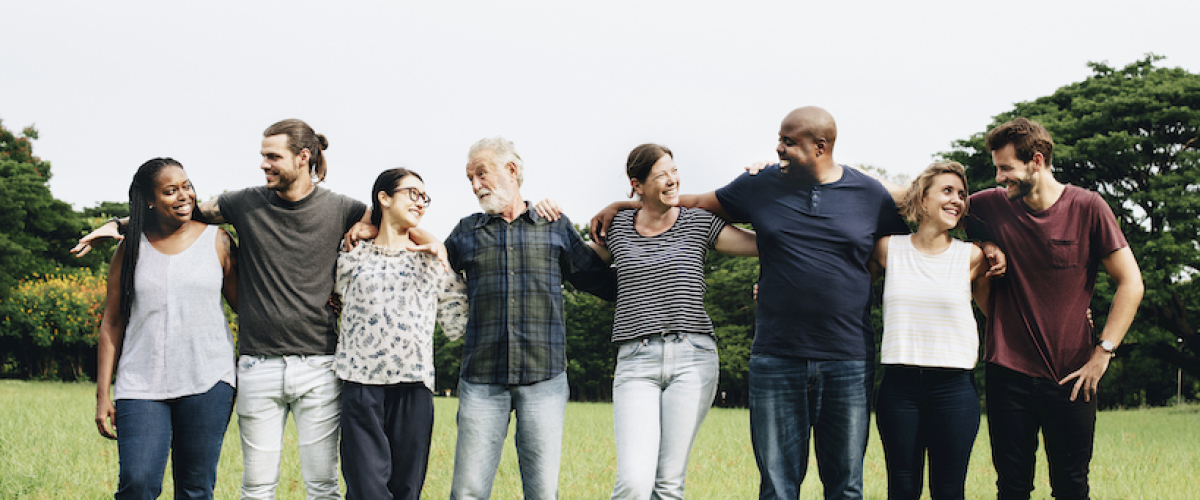 Stock photo of eight people standing in a line with arms linked