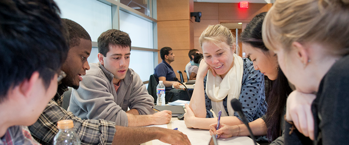 a group of students working together in the classroom.