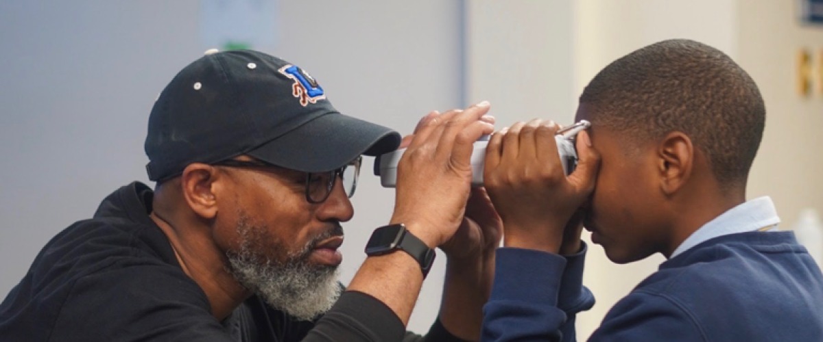 team member showing a child how to do a vision check