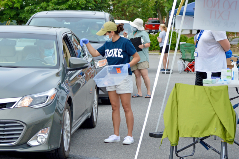 Photo of Duke clinicians working at a drive-in COVID testing site.