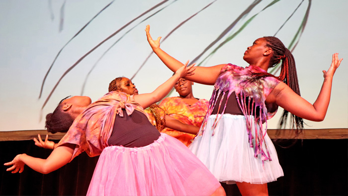 Ethnodrama performers dancing onstage