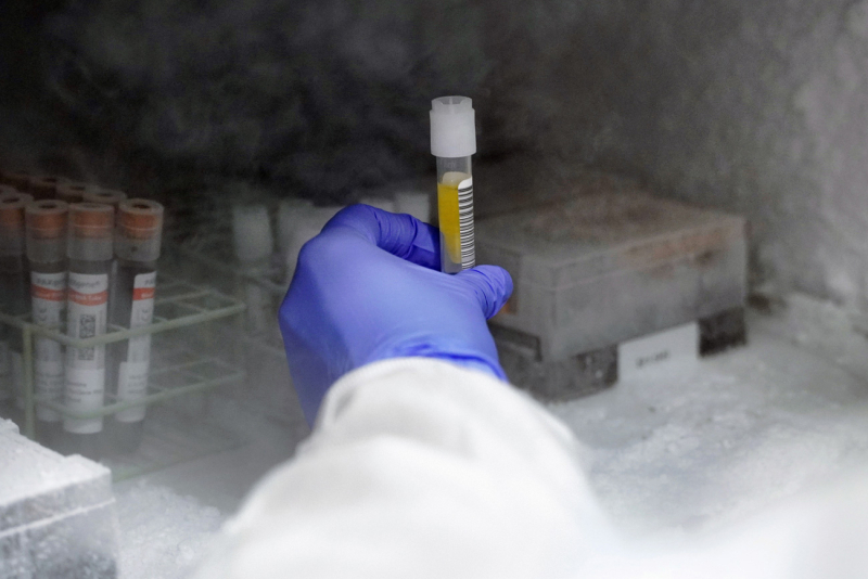 Clinician retrieving sample from freezer.