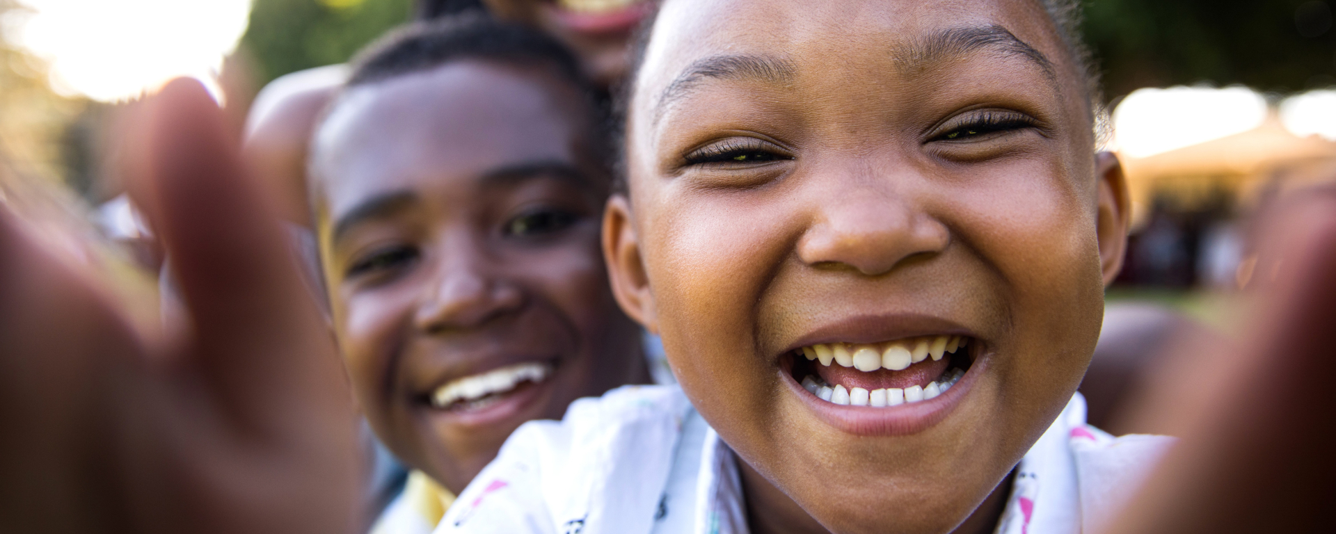 Smiling African American children candid outdoor selfie