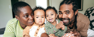 African American mother, father and two infant daughters at home.