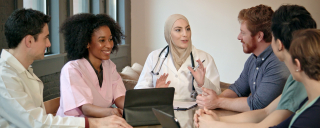 Diverse team of medical research professionals conducting meeting and having a discussion.