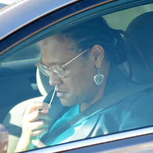 A participant completes a nasal swab test during a drive-through event, part of a study launched in response to the COVID-19 pandemic.