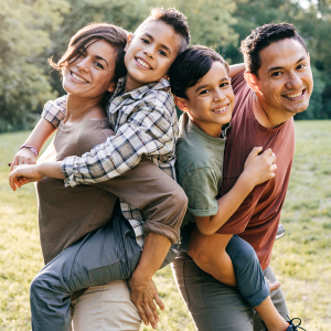 Happy, young family posing outdoors.